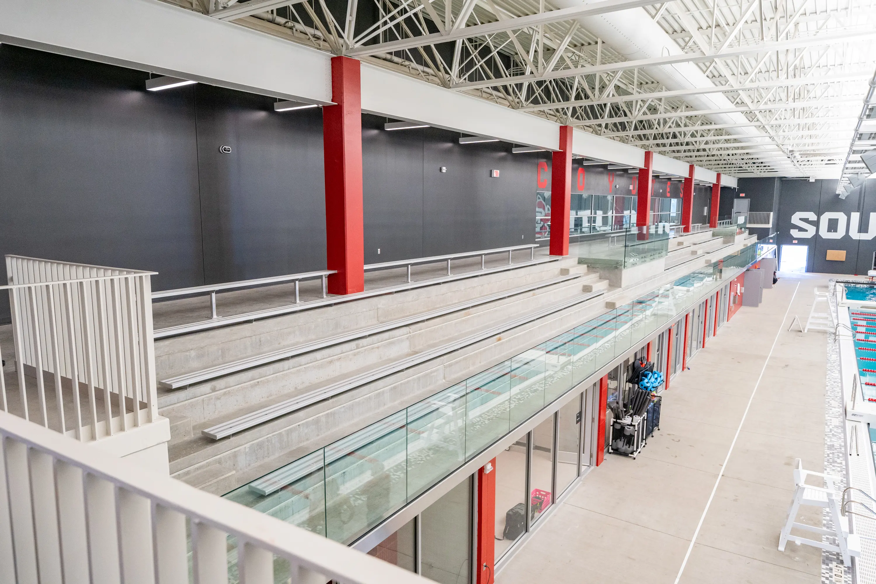 Usd Natatorium Wellness Center 09527 Rear view of stadia structure featuring exposed precast surfaces and red steel supports.