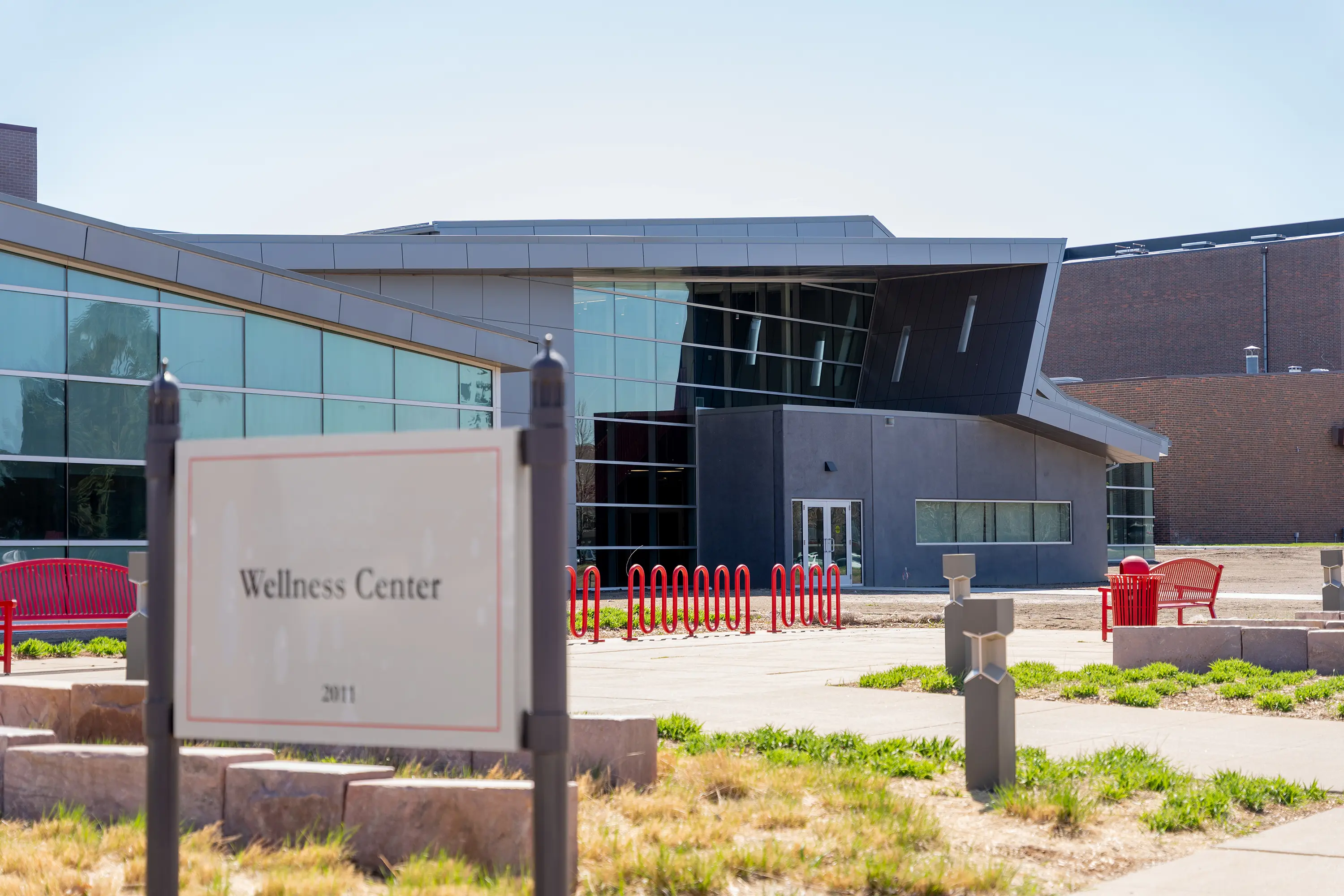 Usd Natatorium Wellness Center 15 Exterior shot of the Wellness Center entrance sign with precast panels and glass facade.