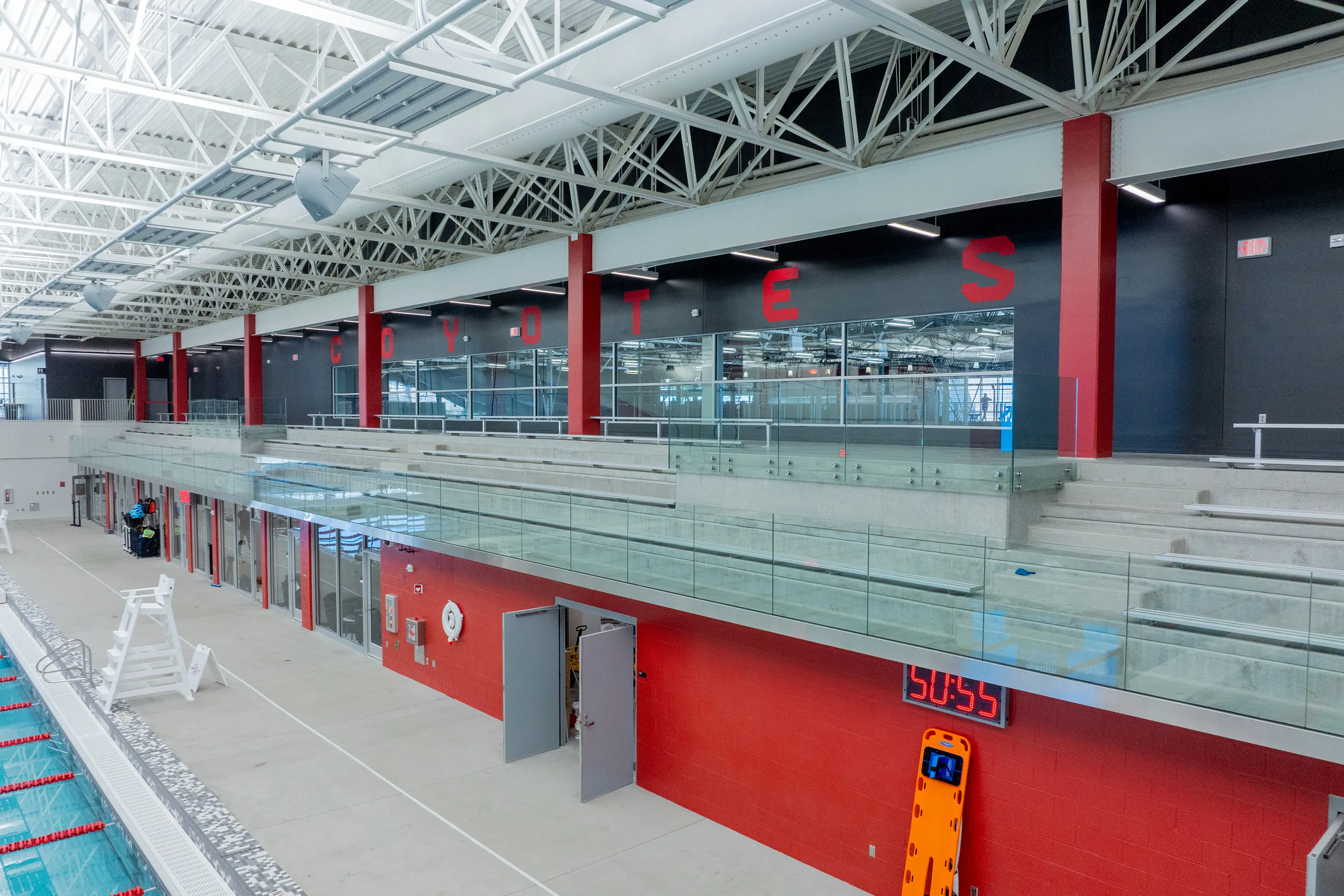 Usd Natatorium Wellness Center 27 View of glass railing and smooth precast stadia leading to upper-level seating.