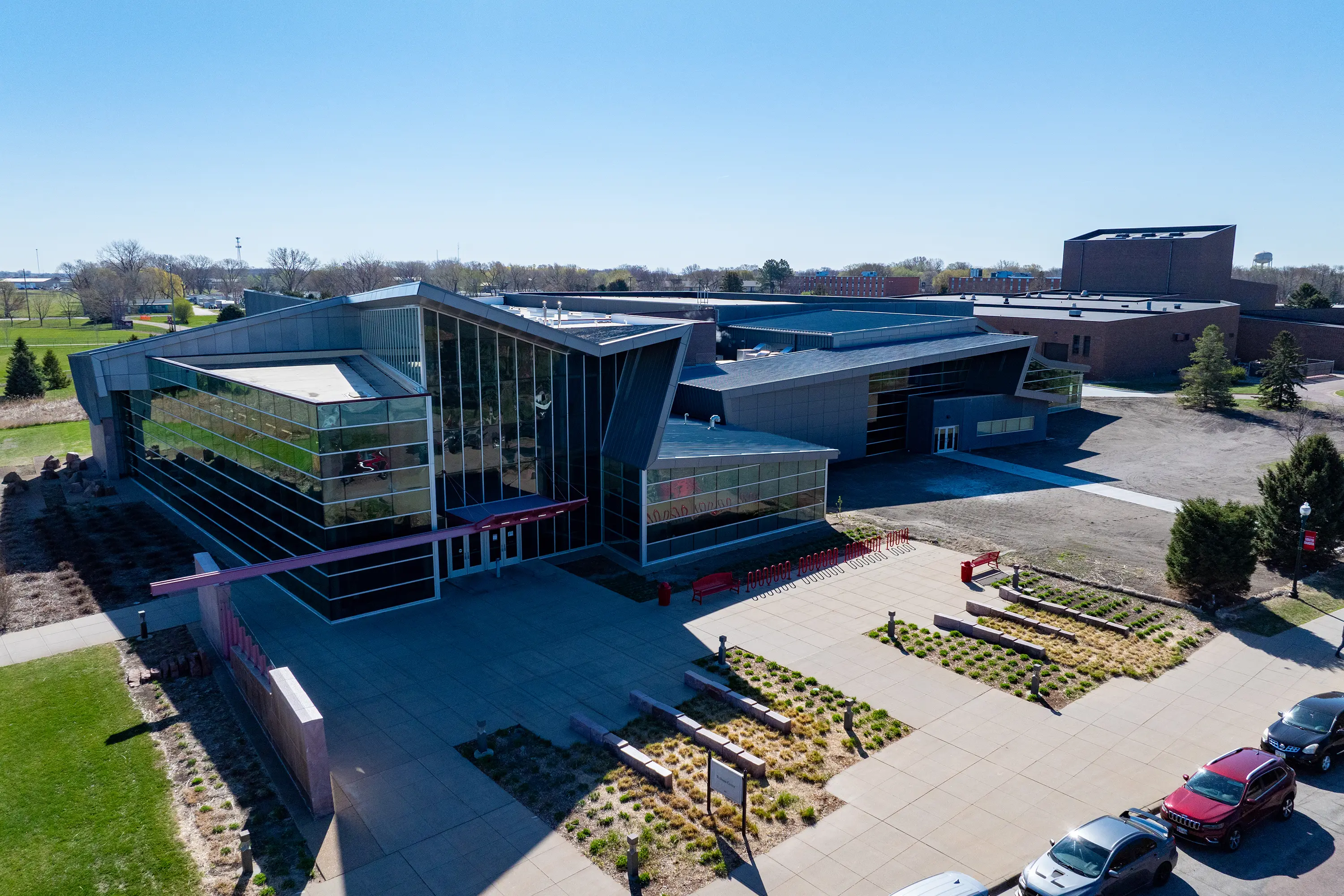 Aerial view of USD Wellness Center exterior showing modern architecture and campus landscaping. Aerial view of USD Wellness Center exterior showing modern architecture and campus landscaping.