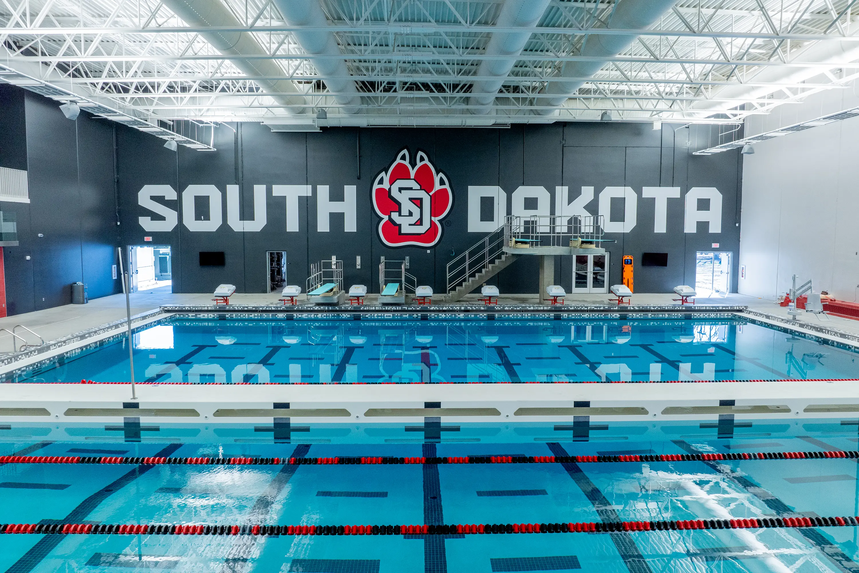 Usd Natatorium Finals 21 Final installed natatorium view featuring calm waters, lane markers, and Gage Brothers’ precast.